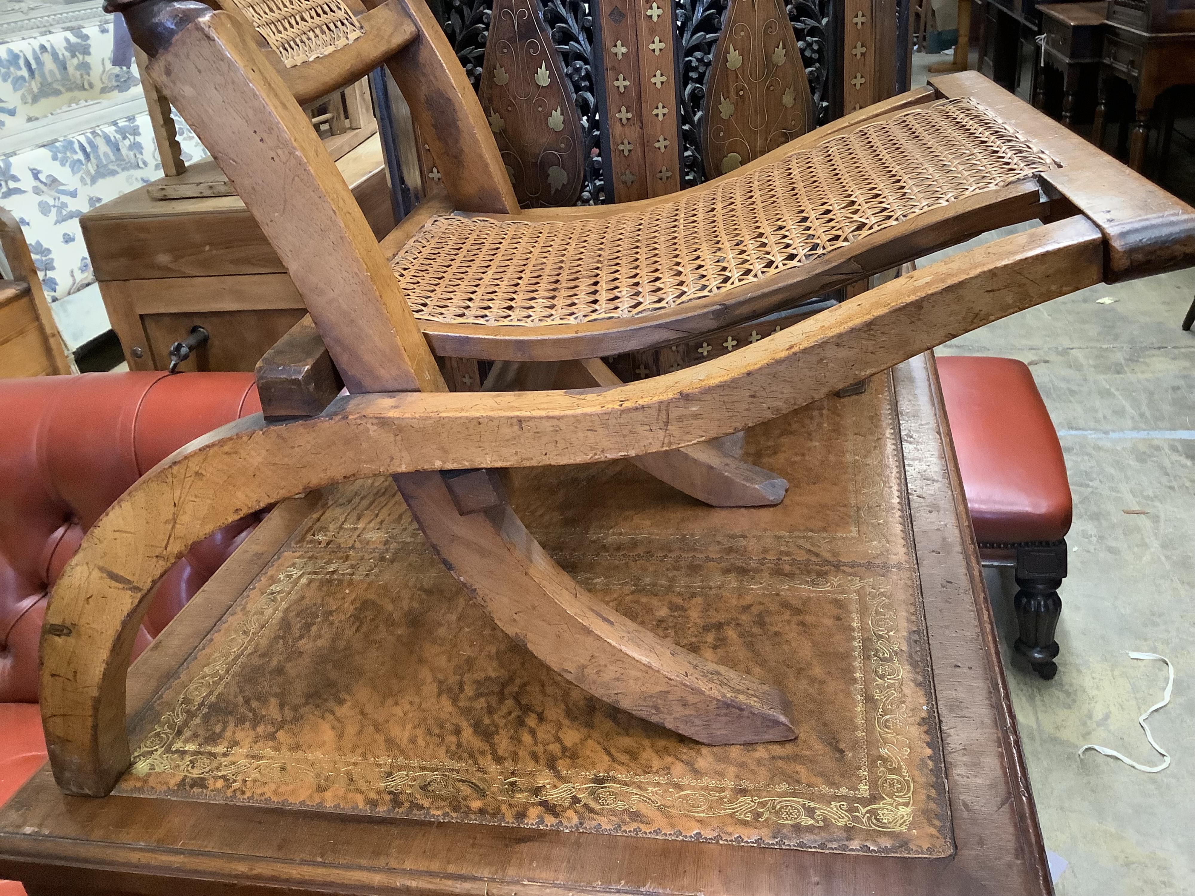 An Anglo-Indian Moorish design octagonal brass-inlaid coffee table, width 61cm, height 64cm on folding stand together with a Victorian cane folding seat chair